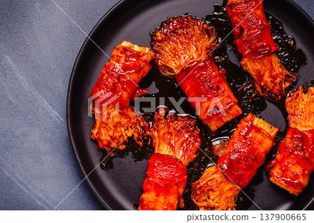 Bacon roll with enoki mushroom grilled with sauce. 137900665
