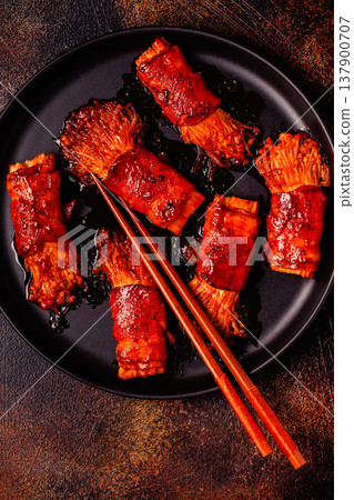 Bacon roll with enoki mushroom grilled with sauce. Bacon roll with enoki mushroom grilled with sauce. 137900707