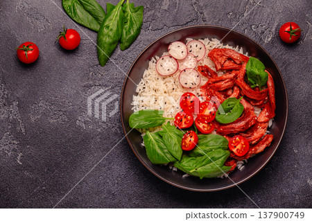 Bowl with vegan fried soy meat and vegetables served with boiled rice. 137900749