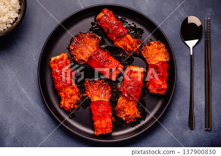 Bacon roll with enoki mushroom grilled with sauce. 137900830