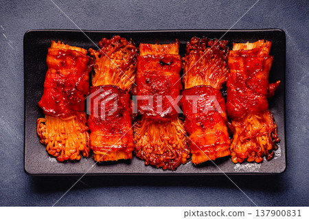 Bacon roll with enoki mushroom grilled with sauce. Bacon roll with enoki mushroom grilled with sauce. 137900831