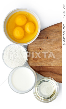 Gathering ingredients for baking with eggs, flour, milk, and oil on wooden board 137901205