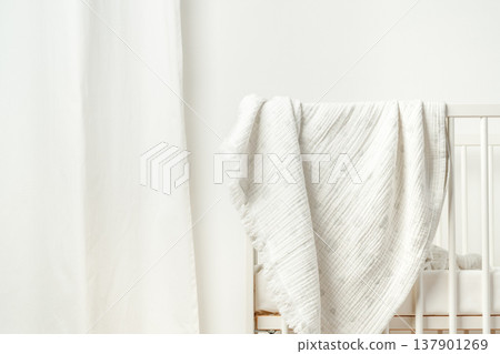 Cozy scene with a crib and blanket in a bright room in the afternoon 137901269