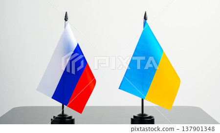Flags of Russia and Ukraine displayed on a table in a neutral setting Flags of Russia and Ukraine displayed on a table in a neutral setting 137901348