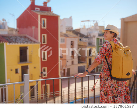 Woman strolls through colorful streets of Spanish coastal town 137901587