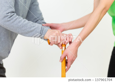 Care workers assisting elderly people with mobility issues. Care workers assisting elderly people with mobility issues. 137901704
