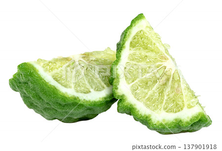 Two fresh slices of green bergamot citrus fruit showing bumpy skin and juicy pulp Isolated. Perfect for food, aromatherapy, or cosmetic concepts. Clean professional macro shot. Two fresh slices of green bergamot citrus fruit showing bumpy skin and juicy pulp Isolated. Perfect for food, aromatherapy, or cosmetic concepts. Clean professional macro shot. 137901918