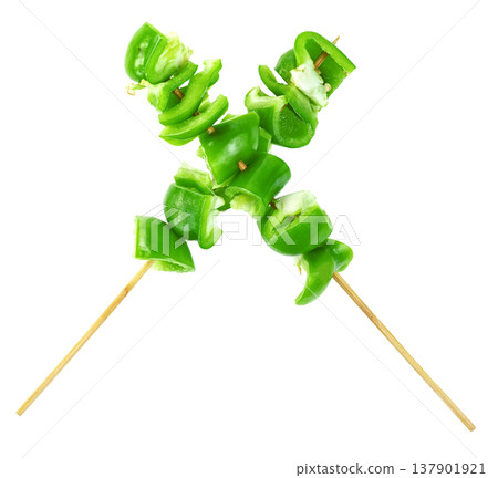 Fresh green bell pepper slices on wooden skewers arranged in an X shape isolated. Healthy vegetable kebab concept, vegan appetizer ingredients for grill or barbecue cooking. Fresh green bell pepper slices on wooden skewers arranged in an X shape isolated. Healthy vegetable kebab concept, vegan appetizer ingredients for grill or barbecue cooking. 137901921