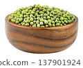 Heap of raw green mung beans in a round wooden bowl isolated. Close-up of organic legumes, a healthy plant-based protein source for cooking and vegetarian diets. 137901924