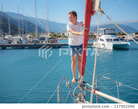 Woman Sailor Handling Sails Preparing For Navigation In Sea 137902090