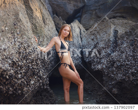 Young woman enjoying serene evening at sea in Krabi, Thailand 137902097