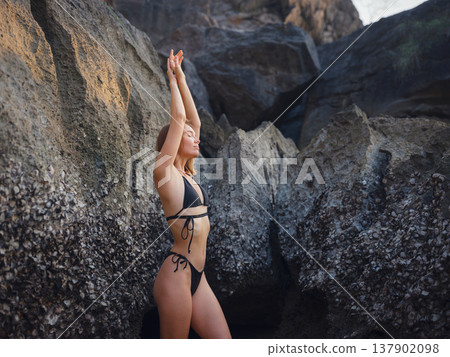Young woman enjoying serene evening at sea in Krabi, Thailand 137902098