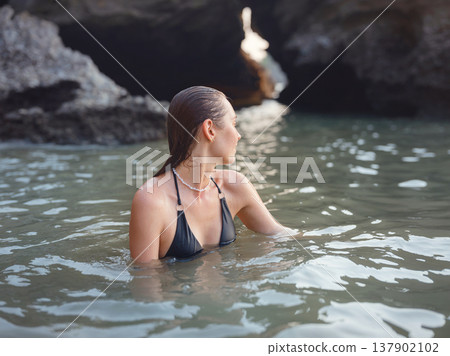 Young woman enjoying serene evening at sea in Krabi, Thailand Young woman enjoying serene evening at sea in Krabi, Thailand 137902102