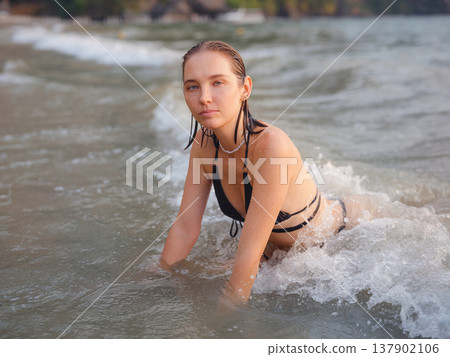 Young woman enjoying serene evening at sea in Krabi, Thailand Young woman enjoying serene evening at sea in Krabi, Thailand 137902106