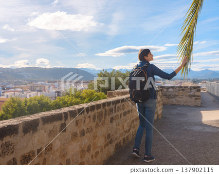 Young woman exploring historic castle in Denia Young woman exploring historic castle in Denia 137902115