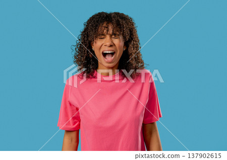 Angry African Teenage girl Yelling At Camera With Expressive Face In Frustration Angry African Teenage girl Yelling At Camera With Expressive Face In Frustration 137902615