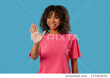 Friendly African Biracial Teenage girl Waving Hand. Hello, Hi.Greetings on blue Friendly African Biracial Teenage girl Waving Hand. Hello, Hi.Greetings on blue 137902630