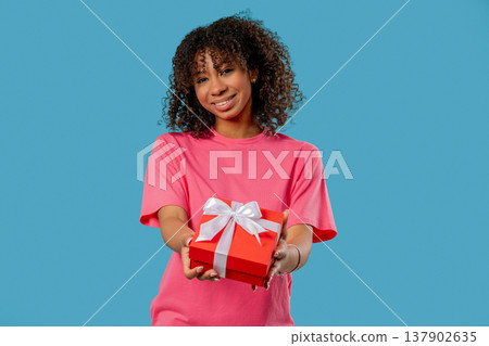 Happy Teen Girl Gift Box On Blue Background. Young Woman Smiling, Gives You Happy Teen Girl Gift Box On Blue Background. Young Woman Smiling, Gives You 137902635
