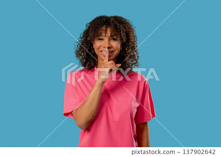 African Teen girl Makes Shush Shh Gesture With Finger On Lips, Silence Signaling 137902642