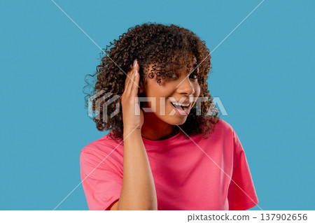 African Girl Pointing To Ear With Confused Face,Signaling She Cant Hear Clearly African Girl Pointing To Ear With Confused Face,Signaling She Cant Hear Clearly 137902656