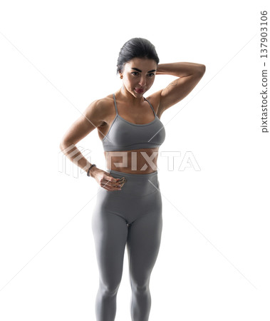 Athletic woman with a strong body wearing an activewear set on a white background Athletic woman with a strong body wearing an activewear set on a white background 137903106