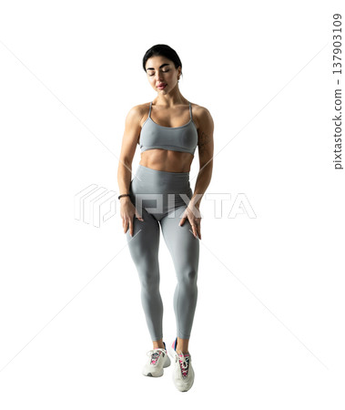 Athletic woman with a strong body wearing an activewear set on a white background Athletic woman with a strong body wearing an activewear set on a white background 137903109