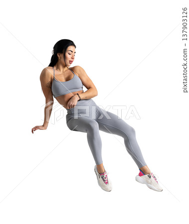 Athletic woman with a strong body wearing an activewear set on a white background Athletic woman with a strong body wearing an activewear set on a white background 137903126