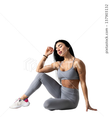 Athletic woman with a strong body wearing an activewear set on a white background Athletic woman with a strong body wearing an activewear set on a white background 137903132