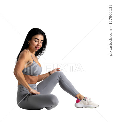 Athletic woman with a strong body wearing an activewear set on a white background Athletic woman with a strong body wearing an activewear set on a white background 137903135