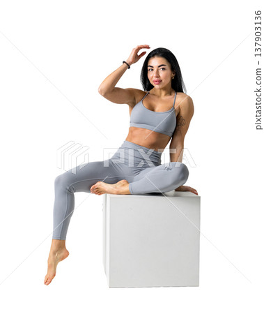 Athletic woman with a strong body wearing an activewear set on a white background Athletic woman with a strong body wearing an activewear set on a white background 137903136