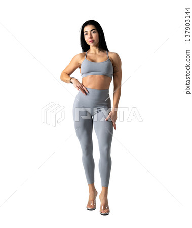 Athletic woman with a strong body wearing an activewear set on a white background Athletic woman with a strong body wearing an activewear set on a white background 137903144