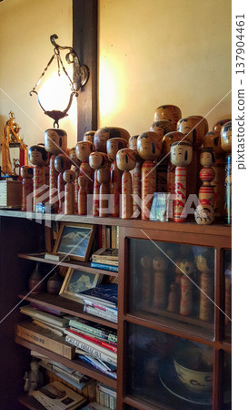 Photo of a collection of vintage kokeshi dolls in a traditional Japanese home 137904461