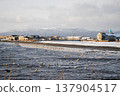 The stunning coastline of a Kuril Islands bay shines at sunset on a sunny winter day. 137904517