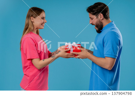 Young Woman Gives Gift Box To Husband Or Boyfriend. Surprise, Unexpected Present 137904798