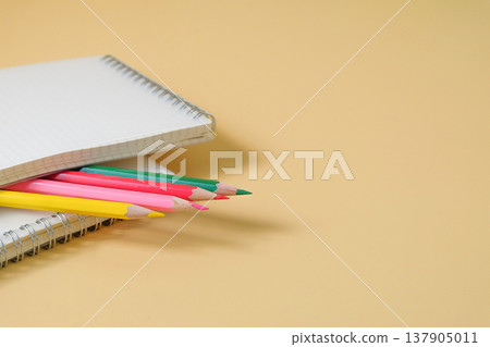 Colored pencils on book note ready for work. Colored pencils on book note ready for work. 137905011