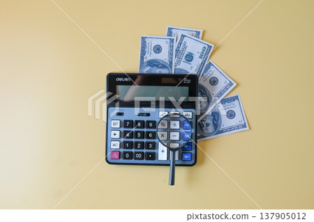 Calculator with magnifying glass,business theme. Calculator with magnifying glass,business theme. 137905012