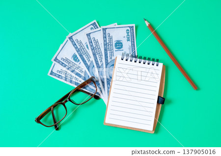 A blank book note and pencil with banknote. 137905016