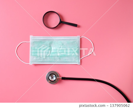 Stethoscope with mask on color background. 137905062