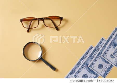 US dollars money bills and magnifying glass,business theme. 137905068