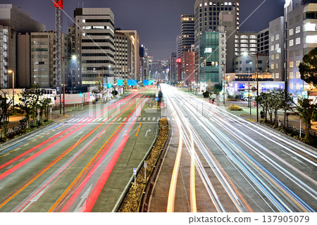 A striking urban night view of Nagoya, featuring the city's skyscrapers and the light trails of cars driving along its main streets (Part 4) 137905079