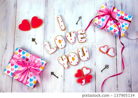 Homemade cookies in the form of a heart or I love you words as a gift to a beloved on Valentine's Day. Homemade cookies in the form of a heart or I love you words as a gift to a beloved on Valentine's Day. 137905134