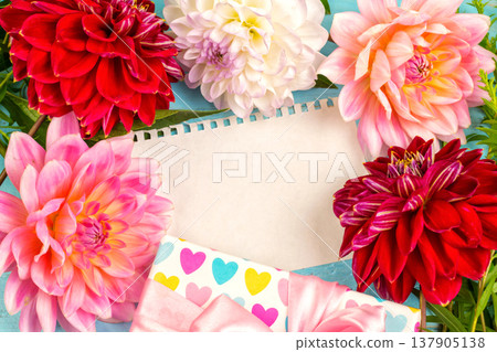 summer background. dahlias and a canvas on a blue wooden background. art. space for a text summer background. dahlias and a canvas on a blue wooden background. art. space for a text 137905138