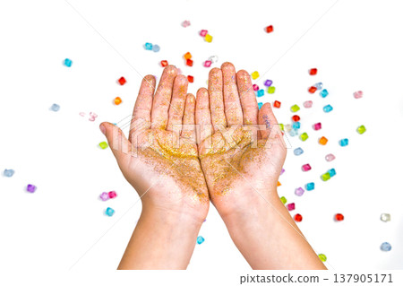 children's hands, hands holding beads on a white background children's hands, hands holding beads on a white background 137905171