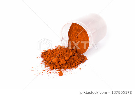 English Red. Bright Red Spice Heaped on a Clean Surface With a Scoop Showing Texture and Color Variation English Red. Bright Red Spice Heaped on a Clean Surface With a Scoop Showing Texture and Color Variation 137905178