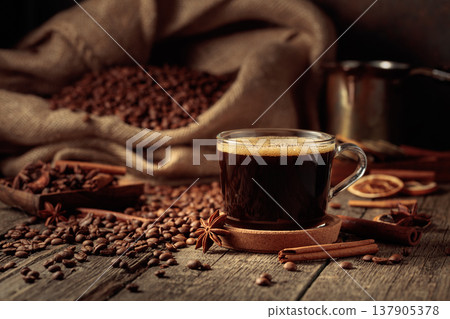 Cup of black coffee on an old wooden table. Cup of black coffee on an old wooden table. 137905378