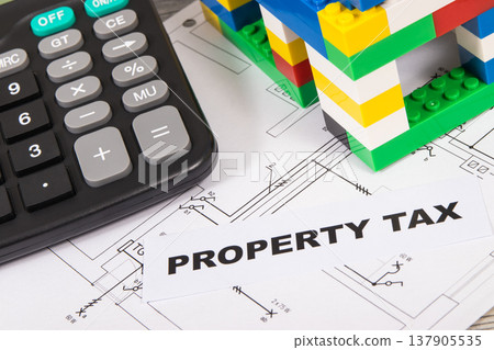 Inscription property tax, calculator, house made of toy blocks and electrical installation plan Inscription property tax, calculator, house made of toy blocks and electrical installation plan 137905535