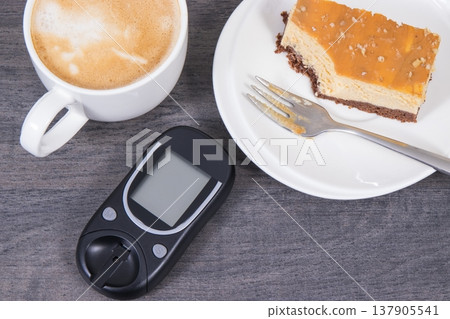 Glucose meter, sweet cheesecake and cup of coffee Glucose meter, sweet cheesecake and cup of coffee 137905541