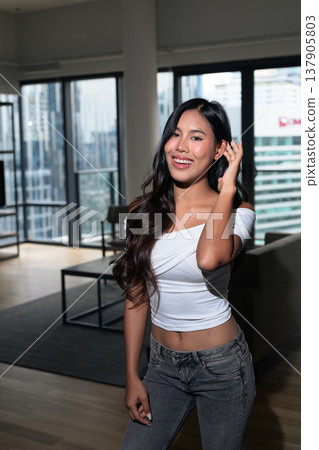 Young Asian woman standing in a modern high-rise apartment with city view in Kuala Lumpur, Malaysia Young Asian woman standing in a modern high-rise apartment with city view in Kuala Lumpur, Malaysia 137905803