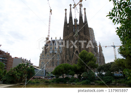 Barcelona, Spain, August 30, 2017: Sagrada Familia under construction with crane Barcelona, Spain, August 30, 2017: Sagrada Familia under construction with crane 137905897