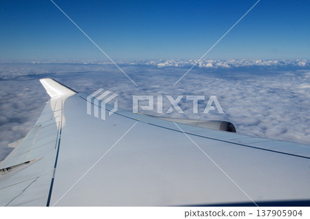 Frankfurt, Germany, 03 November 2017: Airplane wing and engine above the clouds Frankfurt, Germany, 03 November 2017: Airplane wing and engine above the clouds 137905904